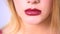 Close up on blond womans red lips