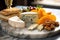 close-up of blue cheese, brie, and cheddar on a marble plate