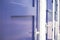 Close up of blue doors against white brick wall at a train station