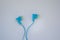 Close-up of  blue earphones, purple background, technology