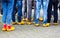 Close up of blue jeans legs of group of people wearing traditional wooden clogs during guided city tour - Xanten, Germany