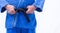 Close up of blue judo uniform, judo-gi, with belt isolated on white