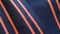 a close up of a blue and orange striped fabric with a red stripe