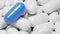 Close up of blue pill capsule in many white pills capsules. Medicine and Specialty Pharmaceuticals concept.,3d model and