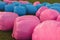 Close-up of blue and pink hay rolls.