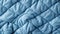 A close up of a blue quilted fabric
