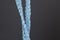 Close up of blue raffia cord on grey background