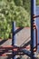 Close-up of a blue and red climbing frame or jungle gym in kids\\\' playground on a sunny summer day in sunlight.