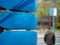 Close up of blue skateboard decks mounted with man walking away