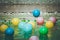 Close up blue small ball on tile floor whith many colorful small ball in the pool foreground in vintage style.