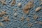 A close up of a blue surface with sand and sea shells. AI generative image