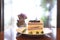 Close up blueberry sponge layer cake topping by blueberry sauce on white plate on wooden table in restaurant, on mirror