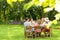 Close-up of blurred leaves in the garden with a group of friends