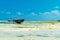 Close up of boat on a beach during large low tide in Nungwi Zanzibar, Tanzania