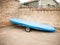 Close up of boating vessel parked on land with blue cover