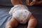 Close-up body parts baby infant chubby boy legs and butt isolated background innocent pure happy smile