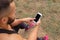 Close-up bodybuilder calling a phone. Muscular man using technology on a blurred background. Active lifestyle concept.