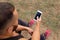 Close-up bodybuilder calling a phone. Muscular man using technology on a blurred background. Active lifestyle concept.