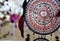 Close up of boho red and black dreamcatcher with feathers in gipsy style