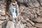 close up of boho styled woman on tropical beach with white pebble