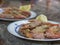 Close up boiled giant red prawns with lemon and garlic on plate