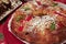 Close-up of a Bolo-rei in a decorative red platter. A traditional Portuguese cake usually eaten around Christmas.