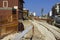 Close up bolted butt of rails and wooden sleepers laid on groundwork crushed stone.