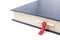 Close-up of a book with bookmark, on white background.