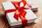 Close-up of a book tied with a ribbon with a bow on a lying on another book: the concept of a good book - a good gift