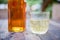 Close up booze glass, booze bottle on the wood table with bokeh light and blur background.