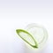 Close up bottle of aloe vera gel with sliced aloe vera leaf on white background, top view.