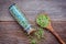 Close up bottle of geen beans with wooden spoon setup on shabby