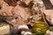 A close-up of a bottle of olive oil surrounded by mushrooms. Vegetable set on a brown paper background.