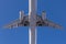 Close-up bottom view of big passenger airplane. Blue clear sky on background