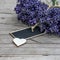 Close up of bouguet of violet purple lavendula lavender flowers herbs with empty wooden pendant and wooden heart, on old rustic