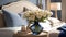Close-up of a bouquet of delicate flowers in a vase on a nightstand near a bed with a headboard, pillows and a blanket