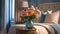 Close-up of a bouquet of delicate flowers in a vase on a nightstand near a bed with a headboard, pillows and a blanket
