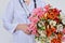 Close-up of bouquet of flowers in hands of female doctor