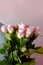 Close-up of bouquet of white, pink roses in hands of young man, brought flowers on date with girlfriend, gives to mom, concept of