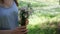 Close-up of bouquet of wild flowers from daisies in hands of a young woman