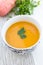 Close up of a bowl of carrot, pumkin and sweet potato soup