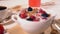 Close up on bowl of cereal and milk with fruit