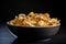 close-up of bowl of crispy, golden chips with salt and pepper