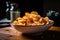 close-up of bowl of crispy, golden chips with salt and pepper