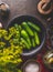 Close up of bowl with cucumber, dill, spices and salt to pickling and preserving on dark rustic background. Healthy fermented food