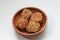 a close up of a bowl of fried stuffed tofu