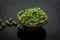 Close up of bowl of raw organic sprouted beans or peas in a small hamper on wooden surface.