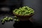 Close up of bowl of raw organic sprouted beans or peas in a small hamper on wooden surface.