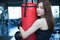 close up Boxer woman hug punching red bag with Boxing Gloves i