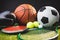 Close up of boxing gloves and basketball football tennis golf balls and discus